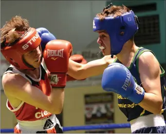  ??  ?? Jack McKenna (right) of St Cianan’s BC unleashes a big right hand against Kieran McPharlin of Ratoath on his way to winning ‘Best Male Boxer’ at the Louth Open in Holy Family BC.