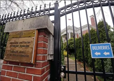  ?? AP Photo/Elaine Thompson ?? Consul: A metal fence surrounds the residence of Russia's consul general Monday in Seattle. The United States and more than a dozen European nations kicked out Russian diplomats on Monday and the Trump administra­tion ordered Russia's consulate in...