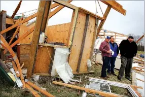  ?? DAVID GOTTSCHALK NWA DEMOCRAT-GAZETTE ?? Terry Hudson (from left) stands Thursday in the debris from his workshop with friends Bill Grady and James Carey after they check on him and his wife Susan on their property on Ray Road near Evansville. Terry and Susan Hudson were in their home when it...