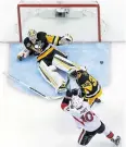  ?? AP ?? Penguins goalie Matt Murray, top, sprawls in an attempt to save a shot.