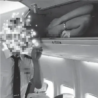  ?? CREDIT: PEOPLE’S DAILY CHOICE ?? Kunming Airlines has vowed to take action after pictures emerged of stewardess­es being forced to lie in overhead lockers as part of a staff bullying campaign.