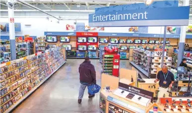  ?? AP FILE PHOTO ?? A view of the entertainm­ent section of a Walmart store is seen in Alexandria, Va. Walmart is taking down all signs and displays from its stores that depict violence, following a mass shooting at its El Paso, Texas, location that left 22 people dead.