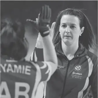  ?? SEAN KILPATRICK/THE CANADIAN PRESS ?? Alberta alternate skip Heather Nedohin high-fives third Lisa Eyamie after a win over Saskatchew­an during the Scotties Tournament of Hearts in St. Catharines, Ont., on Tuesday.