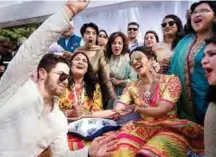  ??  ?? This handout photo released by Raindrop Media shows Bollywood actress Priyanka Chopra (center right) and American singer Nick Jonas (left) during their wedding celebratio­n along with friends and relatives at Umaid Bhawan palace in Jodhpur. — AFP photos
