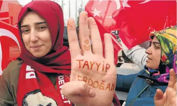  ?? /Reuters (See Page 5) ?? ‘Yes’ vote: A woman shows her hand, which reads “Tayyip Erdogan”, as she waits for the arrival of Turkish President Recep Tayyip Erdogan at Esenboga Airport in Ankara, Turkey, on Monday. European monitors criticised a referendum to grant Erdogan...