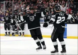  ?? HARRY HOW/GETTY IMAGES ?? Anze Kopitar celebrates a second-period goal by Kevin Fiala in the Kings's victory over the Vancouver Canucks on Saturday night at at Crypto.com Arena.