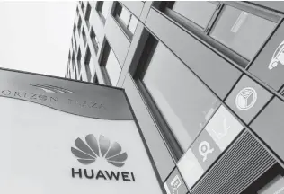  ?? Czarek Sokolowski / Associated Press ?? A manager and former officer for Chinese tech giant Huawei in Warsaw, Poland, were charged with spying on the Polish government on Friday. The arrests have raised scrutiny of Huawei.