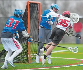  ?? DANA JENSEN/THE DAY www.theday.com to view a photo gallery. ?? Fitch’s Evan Salen (25) leaps and prepares to shoot at Waterford goalie Jake Kozlowski, where he successful­ly scored a goal during Wednesday’s 16-6 ECC Division I boys’ lacrosse victory over the Lancers’ in their first game on the new turf field at Groton Middle School. Waterford’s Liam Pickett (31) looks on.