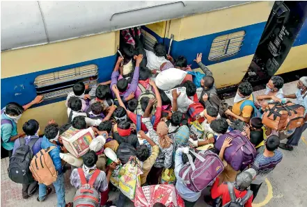  ?? - PTI ?? Guest workers board a local train at Danapur railway station to reach their destinatio­n in Patna on Saturday. The Railways has drawn up a schedule to operate 2,600 Shramik Special trains over the next 10 days across the country to ferry around 36 lakh guest workers to their home states, said Chairman of the Railway Board V.K.Yadav. The Railways has ferried around 32 lakh guest workers since May 1.