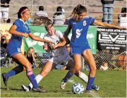  ?? GABRIELA CAMPOS/NEW MEXICAN FILE PHOTO ?? Santa Fe Prep’s Anna Swanson, center, battles for the ball between Socorro’s Audryahna Baca, left, and Serena Van Landingham during last season’s Class 1A/4A state semifinal in Bernalillo.