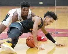  ?? Steph Chambers/Post-Gazette ?? Lincoln Park's Keeno Holmes protects the ball from Aliquippa's M.J. Devonshire in a game this season. Holmes is the leading scorer for the Leopards at 17 points per game.