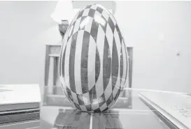  ?? Eric Kayne ?? Gil Baumgarten made this exquisite wooden egg that decorates his Galleria-area office. His former shop teacher, H.B. Taylor, saw it and Baumgarten’s other woodwork after returning from Greece.