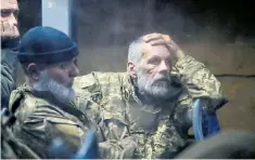  ?? ?? Soldiers who surrendere­d at Azovstal sit in a bus after being taken to the Donetsk region