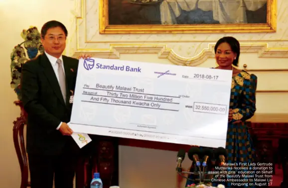  ??  ?? Malawi’s First Lady Gertrude Mutharika receives a donation to assist with girls’ education on behalf of the Beautify Malawi Trust from Chinese Ambassador to Malawi Liu hongyang on August 17