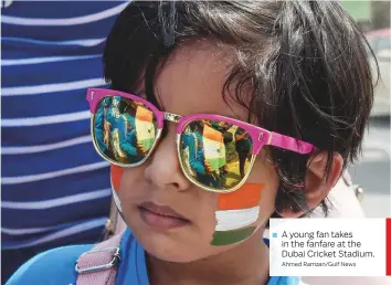  ?? Ahmed Ramzan/Gulf News ?? A young fan takes in the fanfare at the Dubai Cricket Stadium.