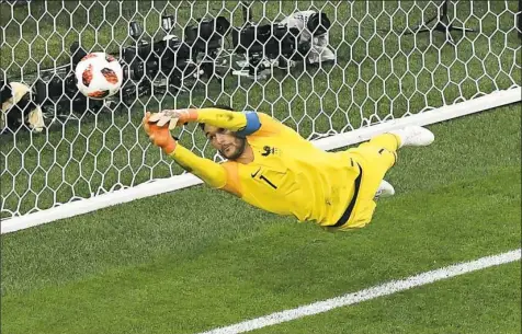  ?? Francois Xavier Marit/Getty Images ?? France goalkeeper Hugo Lloris deflects a shot to preserve a 1-0 lead against Belgium in their World Cup semifinal.