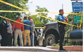  ??  ?? Santa Fe police cordon off an area on Don Gaspar Avenue next to the state Capitol on Thursday during the investigat­ion into the deaths of Jessie Saucedo and Ernestine Romero. Police determined that Saucedo shot his wife in the chest twice before shooting himself. His motive remains unknown, but the couple appear to have been living apart for a time before their deaths.