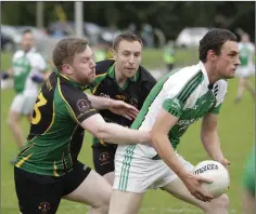  ??  ?? Avondale’s Kevin Sheehan clears the ball while being chased by Seamus Mooney and Brian Flynn. Photos: Barbara Flynn