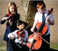  ??  ?? „ The youngsters practise their musical instrument­s.