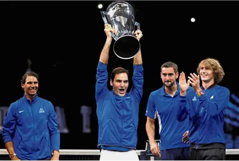  ?? — Reuters ?? Euro style: Roger Federer hoisting the Laver Cup after defeating Team World in Prague on Sunday. Looking on are (from left) Rafael Nadal, Marin Cilic and Alexander Zverev.