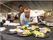  ?? EVAN BRANDT — DIGITAL FIRST MEDIA ?? Ben Mauger admires the rib eye-wrapped asparagus and edamame with Teriyaki sauce served Sunday by SunnyBrook Ballroom and Gatsby’s at the 13th annual Carousel of Flavor.