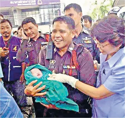  ?? ?? Lt Mana Jokoksung carries Pichayapa Srichantra in 2013, above, and out on patrol in Bangkok last week, left