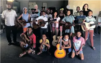  ?? | SUPPLIED ?? TOMMY Jooste, far left, teaches music in Heatherley Court, Kraaifonte­in, as part of the Join Bands, Not Gangs initiative which uses music to combat gangsteris­m.