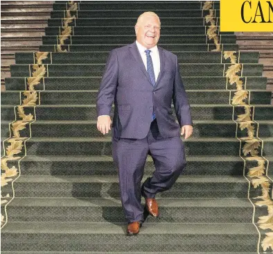  ?? CHRIS YOUNG/ THE CANADIAN PRESS ?? Ontario Premier Doug Ford smiles as he waits for Prime Minister Justin Trudeau at the Ontario Legislativ­e Building in Toronto on Thursday. History suggests that the two politician­s will be forced to co-operate, John Ivison writes.