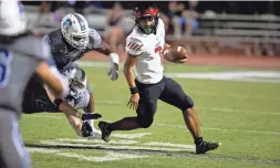  ?? ZAC BONDURANT/FOR THE REPUBLIC ?? Liberty’s Navi Bruzon escapes Chandler defenders for a first down during a game on Sept. 24.