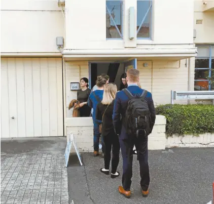  ??  ?? Potential renters wait to inspect a North Carlton property.