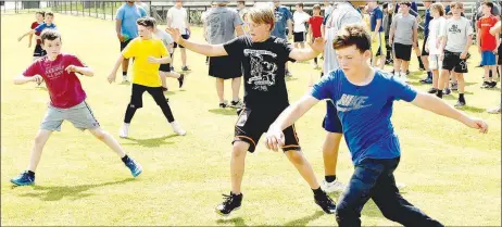  ?? MARK HUMPHREY ENTERPRISE-LEADER ?? A quartet of future Prairie Grove Tigers (from left): Copeland Myers, Noah Barnes, Mayson Chronister, and Chantry O’Brien work on their footwork at Prairie Grove’s football camp.