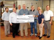  ?? Janelle Jessen/Herald-Leader ?? La-Z-Boy Foundation presented a $3,500 check to The Manna Center on Wednesday to be used to purchase more protein items for the center’s food bank. Pictured are LaZ-Boy employees Jeff McGarrah, materials manager; Rick Wilmoth, controller; Mike Wilmon,...