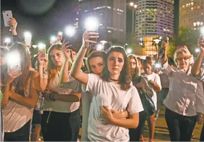  ?? DIRK SHADD/ TAMPA BAY TIMES ?? Mary Claire Foley, center left, 16, embraces Ariana Skafidas, 16, both students at Henry B. Plant High School in Tampa, as they honor victims of the shooting at Marjory Stoneman Douglas High School in Parkland, Fla.