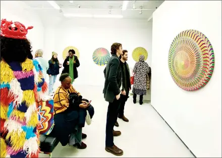  ?? ?? Attendees viewing Carl Andersen’s work at the private viewing of Eye of the Storm: Circulos Vibrante, David Richard Gallery, New York, NY on December 7, 2023. (Photo Courtesy of Carl Hazlewood)