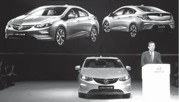  ?? ASSOCIATED PRESS ?? SAIC-GM president Wang Yongping announces the global launch of the Buick Velite 5, an extended range electric hybrid, during a global launch event ahead of the Shanghai Auto 2017 show in Shanghai, China. At the auto show, the global industry's biggest...