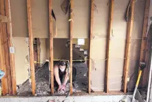  ?? KEN BLEVINS /THE STAR-NEWS/AP ?? Brittany Lewis helps clean debris from a home in the Stoney Creek Plantation neighborho­od in Leland, N.C., on Wednesday. Many of the homes there were flooded throughout their lower floors.