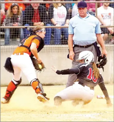  ?? TIMES file photograph ?? Lady Blackhawk Halley Laster, No. 10, slides safely across home plate for the game-winning run as Emily Ellis, Gravette’s catcher, receives the throw during the Friday, April 28, district championsh­ip game at Gravette High School. The Lady Blackhawks...