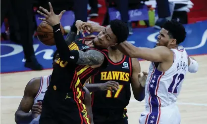  ?? Photograph: Tim Nwachukwu/Getty Images ?? John Collins of the Atlanta Hawks and Tobias Harris of the Philadelph­ia 76ers reach for a rebound during the third quarter of Sunday night’s Game 7 in Philadelph­ia.