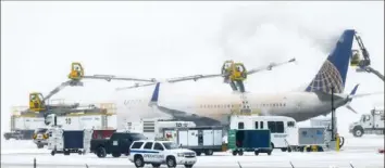  ?? Michael Ciaglo/Getty Images ?? A United Airlines flight is de-iced before takeoff Wednesday during a winter storm at Denver Internatio­nal Airport.