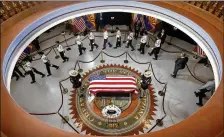  ?? ROSS D. FRANKLINPO­OL VIA GETTY ?? Veterans walk past the casket of Sen. John McCain, R-Ariz., during a memorial service at the Arizona Capitol on Thursday in Phoenix.