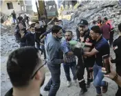  ?? ABDEL KAREEM HANA AP ?? Palestinia­ns carry the body of a child found in the rubble of a house that was destroyed in Israeli airstrikes in the town of Beit Lahiya in the northern Gaza Strip on Thursday.