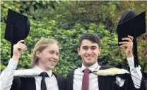  ?? ?? Finally celebratin­g . . . Officially putting their university years behind them are Hayden Sims (left) and Kasam Ali during the Otago University Graduation on Saturday.