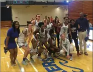  ?? DAVID S. GLASIER — THE NEWS-HERALD ?? Lakeland Community College women’s basketball players and coaches celebrate after an 88-77 win over Sinclair Community College on Feb. 22made the Lakers regularsea­son champions in the OCCAC for the first time since 1996.