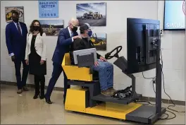  ?? EVAN VUCCI — THE ASSOCIATED PRESS ?? President Joe Biden tours the Internatio­nal Union Of Operating Engineers Local 324 training facility in Howell, Mich., on Tuesday. Michigan Lt. Gov. Garlin Gilchrist, left, and Michigan Gov. Gretchen Whitmer second from left, look on.