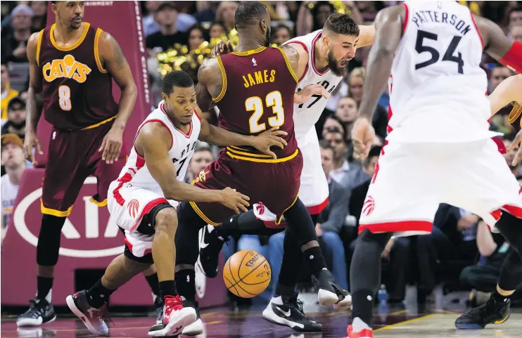  ?? — GETTY IMAGES ?? Kyle Lowry of the Toronto Raptors goes after a loose ball after fighting for a rebound with Cleveland’s LeBron James Tuesday night at Quicken Loans Arena.