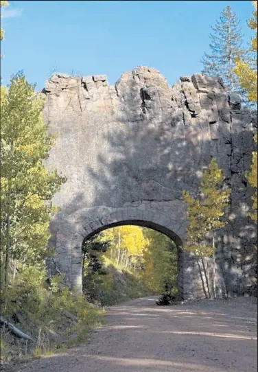  ?? Provided by CDOT ?? The Apishapa Arch east of Cordova Pass on the Scenic Highway of Legends in the Spanish Peaks of southern Colorado was built by the Civilian Conservati­on Corps in 1933-34. Crews tunneled through one of the area's many granite dikes, which were formed by magma eons ago. Crews added the masonry arch to support the dike.