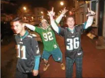  ?? PETE BANNAN – DIGITAL FIRST MEDIA ?? Fans celebrate outside the Side Bar in West Chester Sunday night after the Eagles won their first Super Bowl, defeating the defending champions, the New England Patriots.