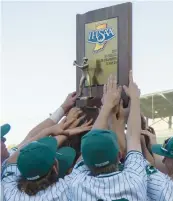  ?? ?? Illiana Christian players hoist the trophy after winning the Class 2A state championsh­ip game against Centervill­e.