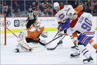  ?? MATT SLOCUM THE ASSOCIATED PRESS ?? Flyers goalie Alex Lyon, left, may have earned the trust of head coach Alain Vigneault, but he could not stop this shot by Montreal’s Tomas Tatar (90) in the first period Thursday.