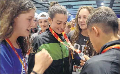 ?? JASON MALLOY/THE GUARDIAN ?? Charlottet­own swimmer Alexa McQuaid, shown here with her teammates, has captured Prince Edward Island’s first medal at the 2017 Canada Games. McQuaid, 15, won silver in the 50-m breaststro­ke in Winnipeg. She matched the medal placing in the pool of her...